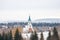 distant view of church surrounded by snowy pines