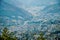 A distant view of closely compacted houses with mountains and paths in crowded hilly rural area, Germany, during sum