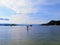 A distant view of a person paddle boarding alone on the open ocean off of galiano island, British Columbia, Canada.