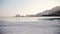 Distant view of sea and beach hotels at daytime. Big building at background. Dead Sea, Israel