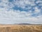 Distant view of Southern Alps mountain range and autumn grassland, New Zealand