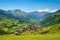 distant view of a sprawling mountain hamlet in summertime