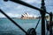 Distant view of Sydney opera house through an old barrier framing it in Australia