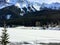 A distant view of the town of Field, in British Columbia Canada, during winter. The landscape is covered in snow and the rocky mou