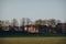 Distant view of two people playing ball in Broomfield Park, London, UK, during golden hour