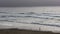 Distant View Of Woman On Northern California Beach
