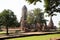 Distant views of the Ayutthaya ruin temple with sunlight and green grass