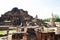 Distant views of the Ayutthaya ruin temple with sunlight and green grass