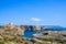 Distant views of a boat and Saint Mary`s Tower in the Island of Comino, Malta