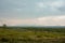 A distant wild plateau in the arctic tundra. Against the background of the distant outlines of the mountains, a cloudy day