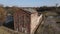 Distillery in Loshitsa Park. Fly over the destroyed old buildings. The collapsed roof and crumbling brick are visible. Lifeless