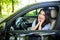 Distracted fright face of a woman driving car, wide open mouth side window view. Negative human face expression emotion reaction.