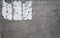 Distressed concrete wall with sign adhesive residue