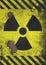 A distressed and corroded rusty metal nuclear radiation warning symbol using yellow and black colors