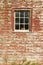 Distressed red barn side and window in Acadia National Park, Maine