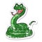distressed sticker of a cartoon happy snake