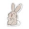 distressed sticker of a cartoon laughing bunny rabbit