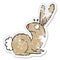 distressed sticker of a cartoon startled bunny rabbit