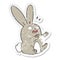 distressed sticker of a cartoon startled rabbit