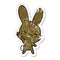 Distressed sticker of a curious waving bunny cartoon