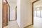 Distributing corridors of a house with light oak flooring and sapele wood doors with access to other rooms with terraces