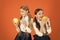 Distributing free fresh fruit at school. Girls kids school uniform orange background. Schoolgirls eat apples. School