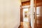 Distributor corridor of a house with glossy oak wood floors, access to other rooms with sapele wood doors and mezzanines of the