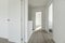 Distributor hallway of a two-story single-family residential home with white wood carpentry on doors and moldings and light-