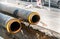 District heating insulated pipes pipeline reparation and reconstruction parallel with the street with construction site metal safe