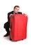 Distrustful business man behind red luggage