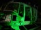Disused abandoned Helicopter grounded at night with green night lighting to show nose body and component parts
