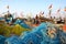 DIU, INDIA - JANUARY 9, 2014: Fisherman working on his net at Vanakbara Fishing port with colorful fishing nets in the foreground