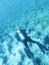 A diver among an endless flock of Fusilier fish at the bottom of the Indian Ocean