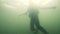 Diver silhouette underwater view. Scuba diving in river water. Diver under water