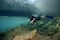Diver underwater, Diveboat & sunbeams