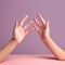 Diverging Paths: Close-Up of Pink Hands Pointing in Different Directions on Pastel Blue Background