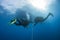 Divers decompressing underwater on a rope