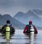 Divers entering water in mountain lake