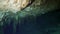 Divers in rocks of underwater cave Yucatan Mexico cenotes.