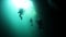 Divers in rocks of underwater cave Yucatan Mexico cenotes.