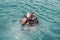 Divers on the surface of water ready to dive