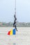 Divers training on the rope near water. Romanian flag.