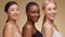 Diverse beauty. Profile portrait of three happy multiethnic women looking at camera and smiling together