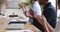 Diverse business people audience sit at conference table clap hands