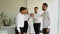 Diverse business professionals high five during a meeting in boardroom