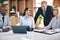 Diverse businesspeople laughing during a meeting in an office