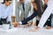 Diverse businesspeople standing in a boardroom solving a jigsaw