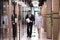 Diverse businesspeople walk down office corridor talking