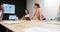 Diverse businesswomen having presentation at office meeting, using laptop and tablet, in slow motion