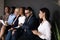 Diverse candidates waiting for job interview, sitting in row